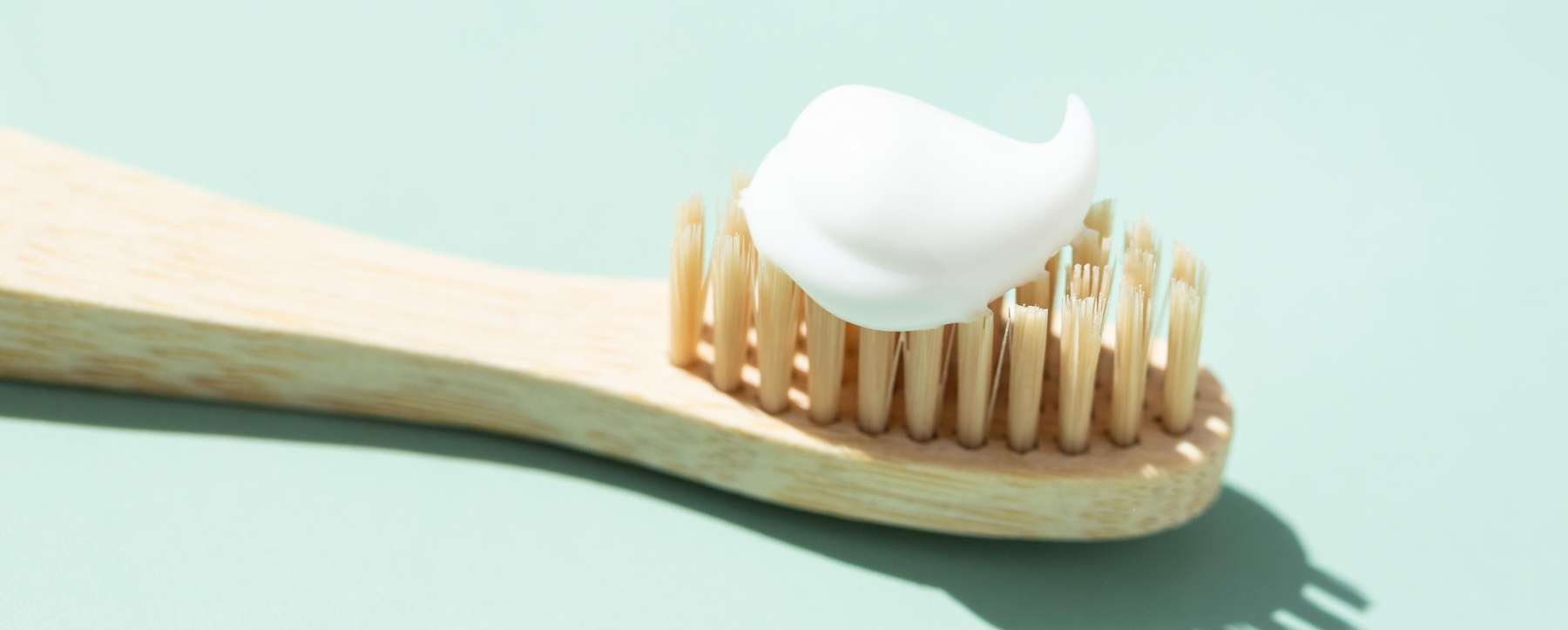 Soft-bristled toothbrush with fluoride toothpaste for protecting enamel after whitening