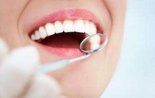 Dentist examining bright white teeth after enamel-safe whitening treatment