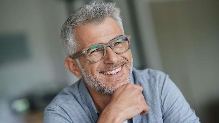 Man with eyeglasses smiling